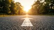 © Umnat - A straight road with a painted arrow leading toward the horizon to symbolize goal setting.