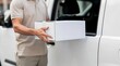 © GUNARTOGRAPHY - Delivery person handing white package box from van.