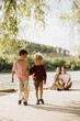 © BGStock72 - Joyful moments of friendship by the lake during a sunny afternoon