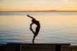 © Metadancer - Hispanic woman practicing yoga acrobatics balancing on a bench