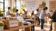 © Moksha - Donation box filled with food and supplies sits on a table in a community center. Volunteers work in the blurred background, organizing goods for a local charity outreach program.