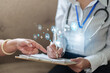 © Natee Meepian - Doctor writing on medical clipboard form with patient pointing during consultation