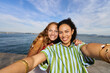 © Alvaro Lavin/Stocksy - Happy women friends taking selfie by the sea