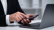 © Studio KN - mobile business management. corporate communication and instant messaging solution. digital multitasking workflow. businessman using smartphone alongside modern laptop computer.