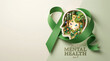 © Shopibizz - Paper craft human silhouette with green ribbon filled with flowers and trees for World Mental Health Day.