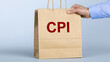 © photo for everything - A business person hand hold paper bag with inflation acronym concept text for economic market cost index analysis and financial data report