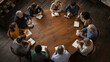 © Lemon Pop Studio - High Angle View of Diverse Professionals Sitting Around a Round Wooden Table for a Business Seminar or Support Group Meeting