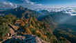 © zhou yan - Autumn mountain panorama with golden peaks, traditional pavilion, cloud sea, and dramatic sunbeams. Wide-angle landscape with right copy space, ideal for travel campaigns, hero banners, and web...