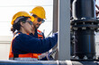 © unikyluckk - A male and female engineer at Cooling tower operations, Induced draft cooling towers service. Team of engineer or technicians maintenance and repair of cooling towers at solar farm.