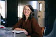 © OchreOchre/Stocksy - Smiling Businesswoman in Modern Office, a Portrait