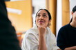 © OchreOchre/Stocksy - Thoughtful Young Woman Smiling During Office Team Meeting