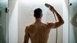 © panumas - Man taking a refreshing shower in a modern bathroom