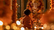© Amit - Rear view of a young boy sitting and praying in front of Lord Ganesha idol during Ganesh Chaturthi