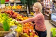 © Prostock-studio - Smiling Elderly Caucasian Woman Selecting Fresh Fruits In Supermarket. Enjoying Shopping Experience While Choosing Organic Produce For A Healthy Diet In Grocery Store. Healthy Lifestyle Concept.