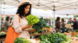 © Nai - Woman shopping for fresh vegetables at a farmers market on a sunny day
