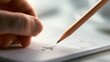 © Daria - Hand holding a sharpened pencil drawing a small airplane on open planner or calendar page under soft natural light with thoughtful close-up focus on creative de