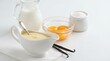© PhotoHub - Ingredients for homemade vanilla custard with milk, egg yolks, sugar and vanilla beans isolated on white background