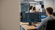 © mangolovemom - Software developer computer coding office teamwork data monitor dashboard programmer technology, software developer working computer modern office while colleagues collaborate near whiteboard