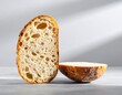 © Tang - Freshly Baked Sliced Bread With Crisp Crust on Wooden Surface