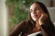 © PheelingsMedia - Woman thinking at home looking away