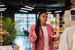 © Rido - Young curvy black businesswoman talking to colleague at office