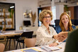 © Rido - Successful businesswoman shaking hands with businessman at office