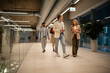 © Zoran Jesic - Business colleagues walking office hallway having conversation
