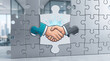 © Inspire Shots Hub - Puzzle pieces forming a handshake, symbolizing partnership, agreement, and business success within a modern office setting