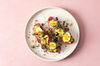 © pundapanda - Fresh sandwiches made with gluten free bread topped with beetroot hummus, pesto, boiled quail eggs, and microgreens served on a simple plate