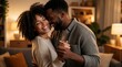 © Lubov - Happy young black couple dance together in cozy living room at night. Smiling man, woman hug laughing during romantic moment at home. Loving african american partners enjoy fun time, celebrating
