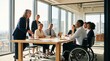 © Ainur - Diverse professional team including man in wheelchair listening to senior female leader during collaborative meeting in modern office