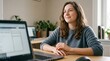 © creativestock - Young woman working on laptop at home office desk looking thoughtfully into the distance