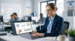 © gabriel - Businesswoman analyzing data on a laptop in a modern office environment
