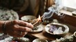 © Nelson - A hand holding a burning sage smudge stick with smoke rising in a spiritual setting.