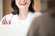 © kapinon - An image of a clinic where a female doctor interacts with patients, explaining things with a smile during medical counseling, examinations, and health consultations—a close-up of her mouth and hands,