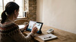 © AI_ID - Woman using a digital tablet for a remote healthcare consultation with a professional doctor from home