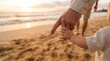 © Thumbs - Father holding baby's hand walking on the beach at sunset