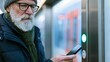 © Anastasiya Marchenko - Senior man using smartphone at station
