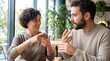 © SunNature - Deaf couple communicating with sign language in a cafe
