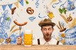 © master1305 - Surprised Bavarian man holding grilled sausage beside beer mug in Oktoberfest design. Concept of beer and food pairing, pub advertising and restaurant offers.