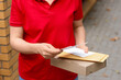 © Pixel-Shot - Delivery service and logistics, courier holding cardboard box and envelopes for parcel shipment at residential address for e-commerce and online shopping