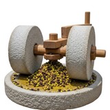 A rustic stone mill grinds fresh green and black olives into a rich paste using traditional granite wheels for authentic oil production, basin, mill, rustic