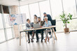 © deagreez - Modern office scene featuring diverse professionals collaborating on a business project in a contemporary workspace