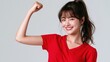 © Hello Stock - Young asian woman in a red tshirt flexing her arm to show strength and confidence, isolated on white background