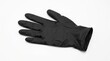 © shah - Black nitrile glove on white background, disposable latex medical glove for protection, sterile rubber hand covering for healthcare and hygiene