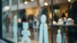 © Rajia - White silhouette figures displayed on a storefront window blurred background