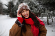 © Home-stock - Young woman with pained expression touching head, standing outdoors in snowy forest