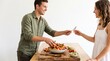 © Segati - Couple preparing and sharing a healthy fresh fruit salad together in a bright kitchen
