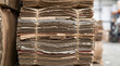 © MSTISHITA - A large stack of old newspapers tied together with plastic twine waiting for recycling at a warehouse facility during the day time