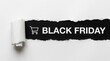 © MST HAFSA - Black Friday text with shopping cart icon revealed through torn paper with white background